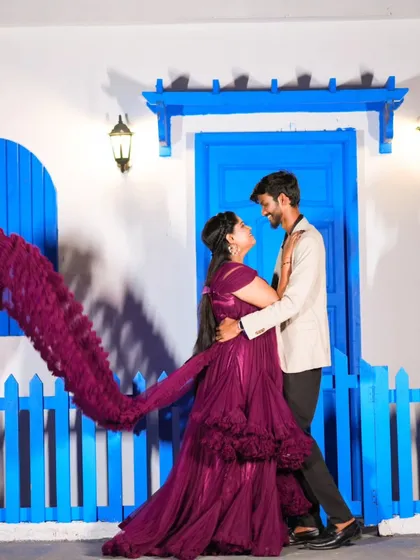 A romantic dance pose with the bride's purple gown trail creating a beautiful effect. This is a perfect shot for a modern pre-wedding album.