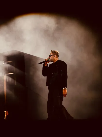 An atmospheric shot of the legend Yo Yo Honey Singh, using smoke and a single spotlight to create a dramatic, moody portrait during his live performance. This is what dynamic concert photography is all about.
