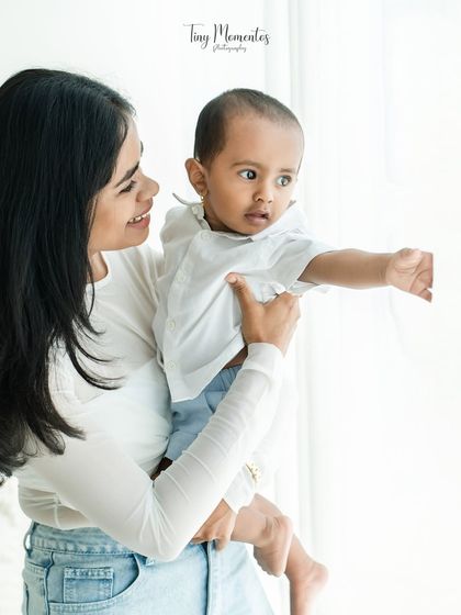A mother showing her baby the world. These quiet, shared moments are just as important as the big smiles.