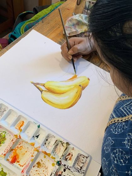 A student's realistic watercolor painting of bananas. This piece shows a mastery of layering and blending to achieve a lifelike appearance.