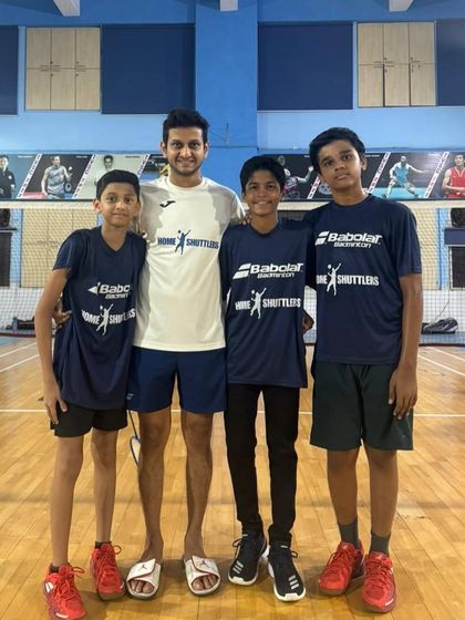 A coach with his team of DSO under-14 runners-up: Vikhyat, Jaynil, and Vihaan. Team events build camaraderie and teach players the importance of supporting one another.