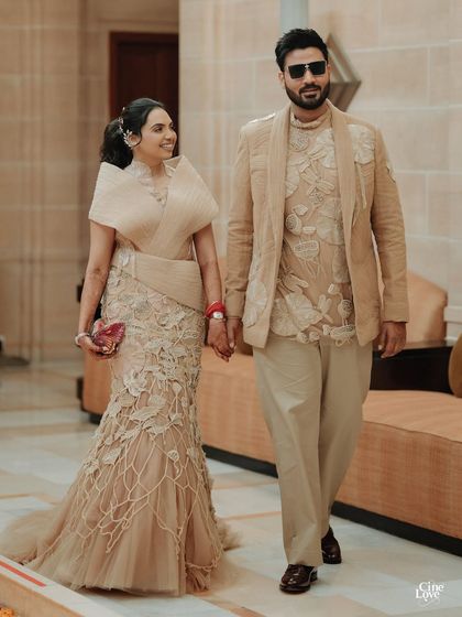 Nikita and Abhinav at their welcome lunch. His tailored beige jacket and kurta perfectly match the tone of her custom Abhishek Sharma gown, creating a chic, coordinated look.