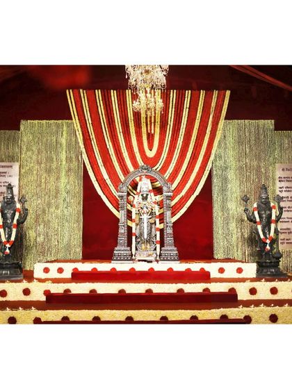 This stage setup features the central deity flanked by guardians, creating a sacred space where cultural symbolism meets modern elegance. The design provides a perfect backdrop for a wedding that honors tradition.