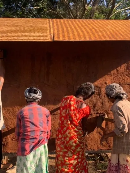 Our all-women team applying the final touches to a mud wall. This project is about more than just building; it's about empowering these women in every aspect of their lives.
