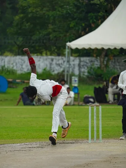 The follow-through of a fast bowler after delivering the ball. This image captures the raw energy and athleticism required to compete at a high level.