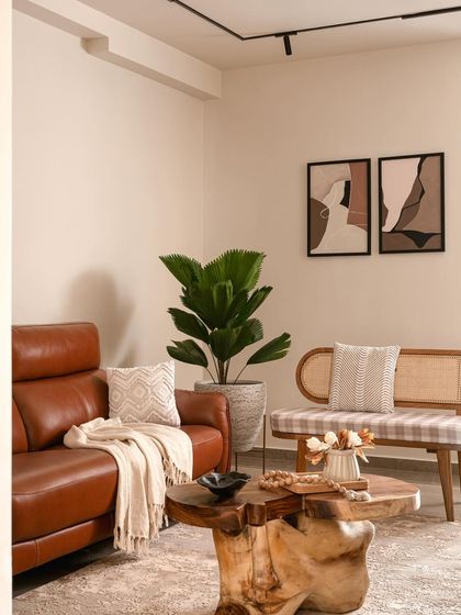 This living room from my Miyu project is defined by clean lines and natural textures. A comfortable leather sofa is paired with a cane bench and a solid wood coffee table, creating a simple, uncluttered, and functional space with organic charm.