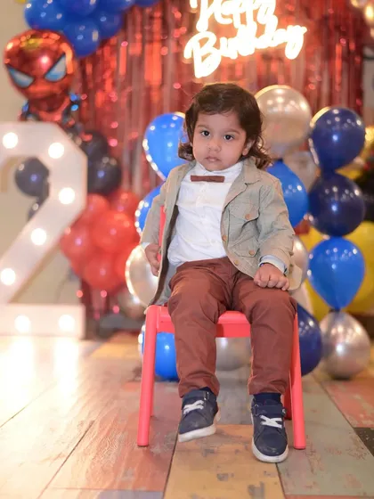A full-length shot of the birthday boy at his Spiderman-themed celebration.
