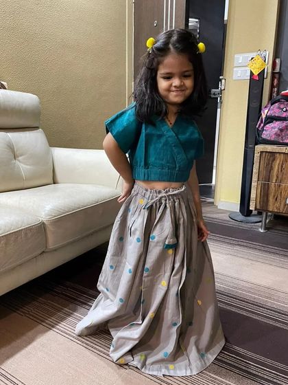 Another adorable shot of little Riva posing in the Handloom Polka Ghagra Choli. Her happy expression shows just how comfortable she feels, even while dressed up for a special occasion.