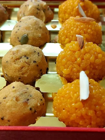 Our festive ladoos are a sight to behold. This box, prepared for a Karva Chauth sargi order, contains delicate motichoor ladoos garnished with almond slivers and seeded panjiri ladoos for energy.