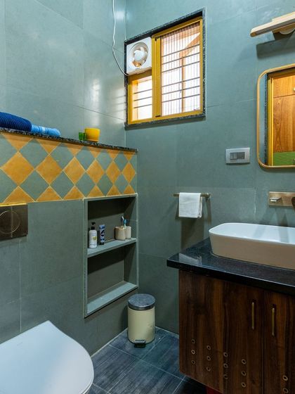 A wider view of the toilet area, showing the built-in niche and the consistent use of natural stone.