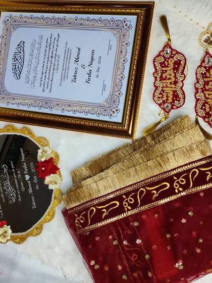 A full view of the maroon and gold Nikah set, showcasing the 'Qubool Hai' dupatta, the 'Masha-Allah' hangings, the personalized mirror, and the framed certificate.