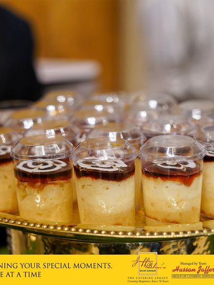 Sweetening your special moments, one bite at a time. This image shows a tray of our popular milk cake desserts served in individual cups, a perfect bite-sized sweet for guests to enjoy.