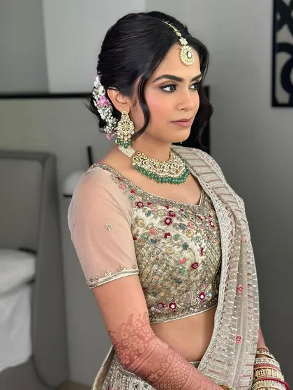 A side view showing the soft waves in her hair and the delicate makeup. This look was meant to turn heads with its understated perfection.