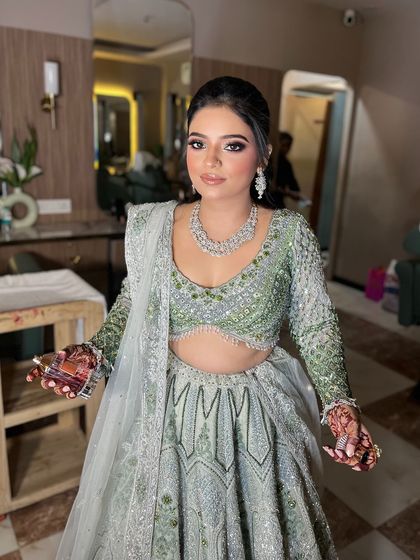 The full look, showing how the soft makeup and elegant hairstyle work with her stunning lehenga.