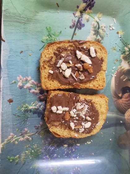 The finished product. A delicious chocolate rusk topped with nuts and sprinkles, made entirely by the student. This gives them a wonderful sense of accomplishment.