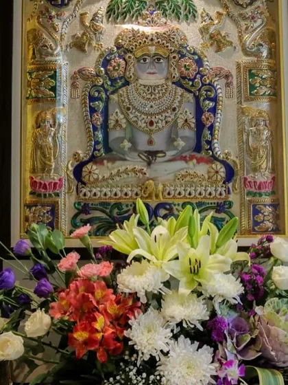 Even a small floral arrangement can add a layer of devotion. This bouquet of fresh lilies, chrysanthemums, and other colorful blooms was placed to honor the deity, bringing natural beauty and fragrance to the sacred space.