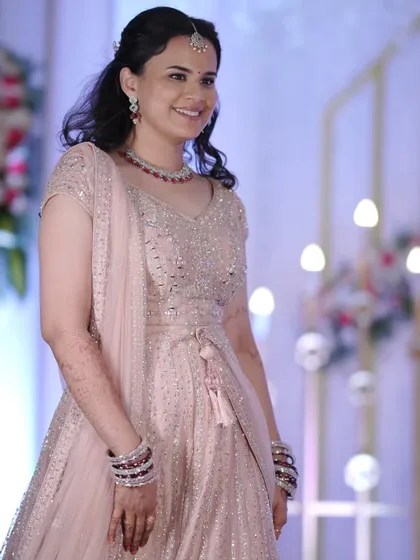 Your reception is a time to shine! For this bride, we went with a soft glam lehenga look. The makeup is radiant with a focus on glowing skin and a subtle smokey eye, ensuring she looks stunning all evening.