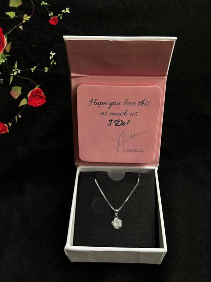 Unboxing a beautiful silver necklace from GIVA. This shot captures the excitement of receiving a special piece of jewelry, perfect for gifting campaigns.