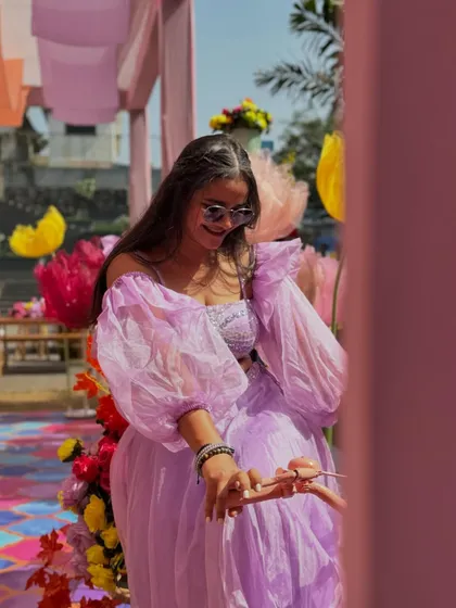 A candid moment during a colorful Haldi ceremony. The decor was full of bright flowers and playful elements, creating a truly happy and festive 'savera'.