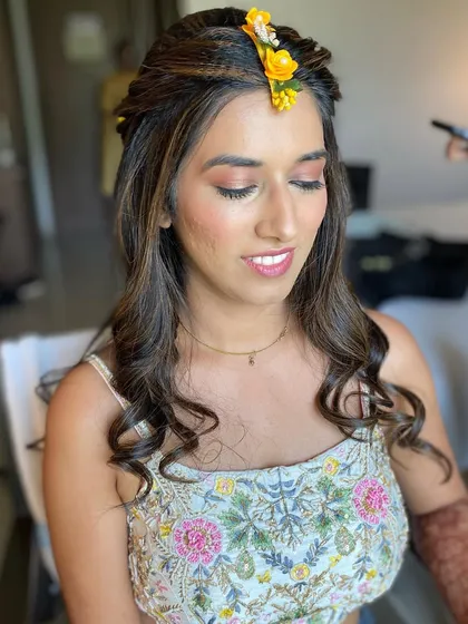 A smiling bride-to-be at her Haldi ceremony. The natural makeup look is perfect for a daytime event, keeping her looking fresh and radiant.