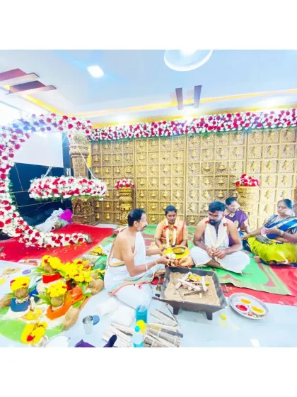 The sacred pooja taking place in front of the crescent moon floral arrangement. It's an honor to create the backdrop for such an important family ritual.