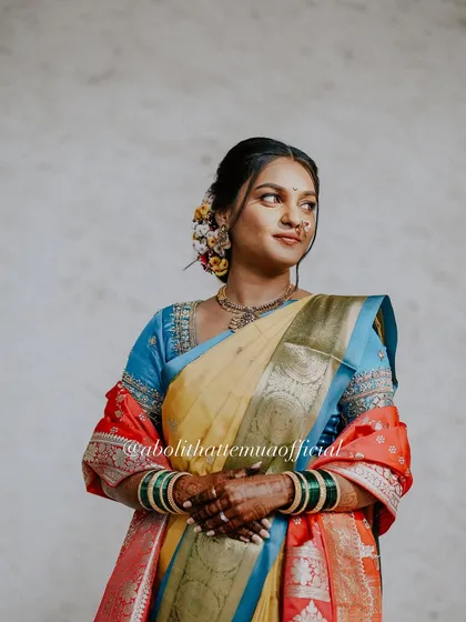 A full-length view of this bride's unique saree combination. The makeup is kept soft and elegant to balance the vibrant colors of her attire.