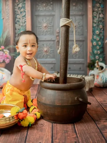The classic pose of Krishna as 'Makhan Chor' (butter thief), with his hand in a large pot.