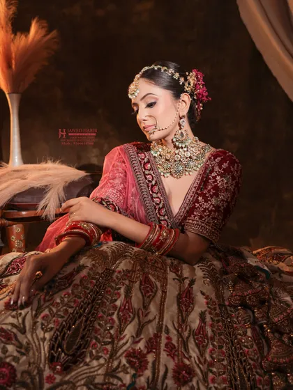 A seated portrait of a bride, showcasing the full effect of the makeup, hair, and outfit. Our portfolio shoots help students build a collection of such high-quality images.