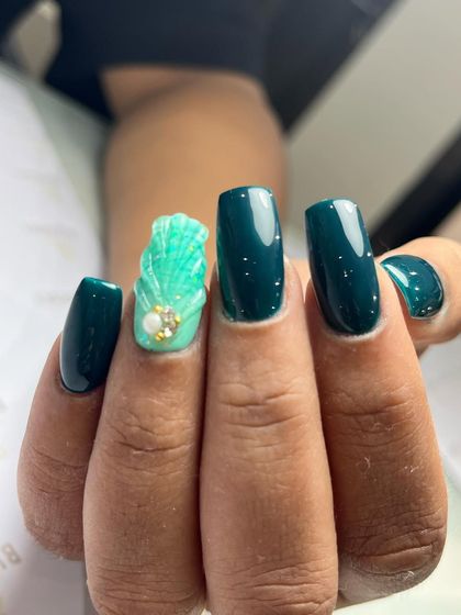 An example of a structured nail set using gum gel for extensions. This look features a deep teal color with a textured 3D seashell accent nail, perfect for a beachy or mermaid-inspired theme.