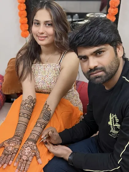 A happy client posing with me during her mehandi session. We build great relationships with our clients, many of whom return to us for every occasion.