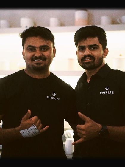 Two of our team members posing with a smile. We're a family here, and we're happy to welcome you.