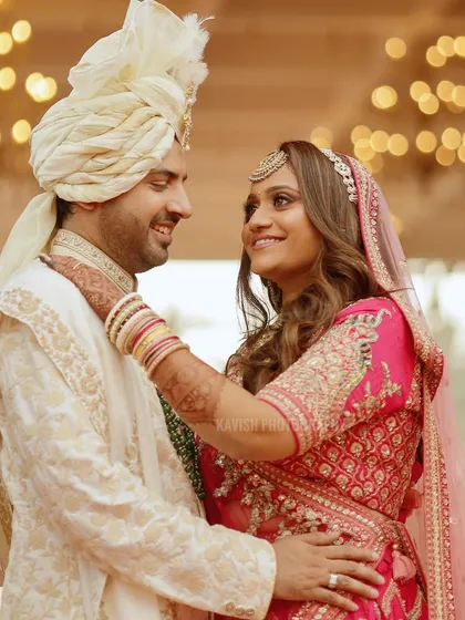 A tender moment where the bride adjusts the groom's attire, showcasing a small, intimate gesture on their big day.