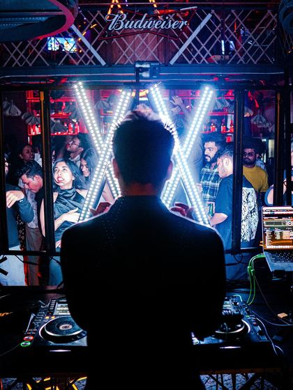 A view from behind the decks, looking out at the crowd through my custom light setup.