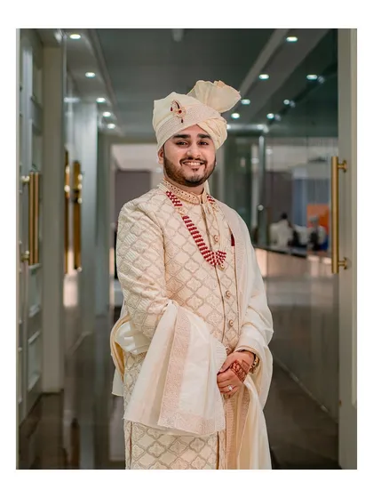 A classic and elegant portrait of the groom in his wedding attire, looking happy and ready for the big moment.