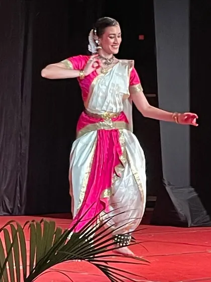 Performing on stage with one of my students. This image reflects my role as a guru, guiding the next generation of dancers and sharing the stage with them.