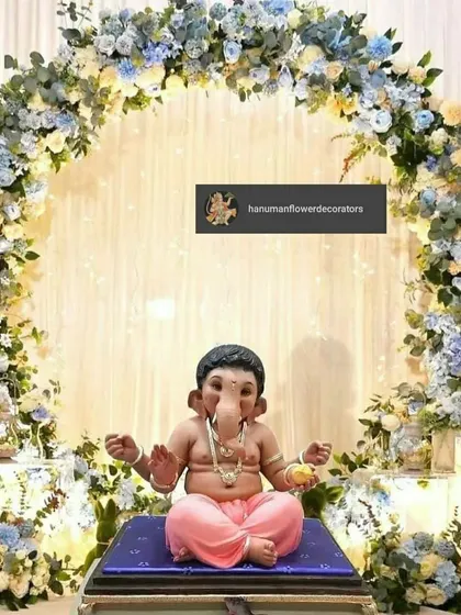 For a modern Ganesh Chaturthi celebration, I designed this serene circular arch using a mix of blue and white flowers. This setup creates a peaceful and beautiful focal point for your Ganpati idol at home.