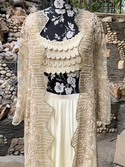 The jacket features a beautiful scalloped border with intricate embroidery.