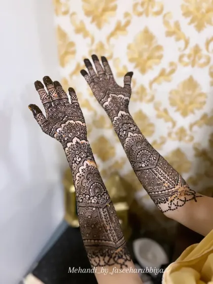 A full view of the same engagement henna, showing how the patterns complement each other across both arms.