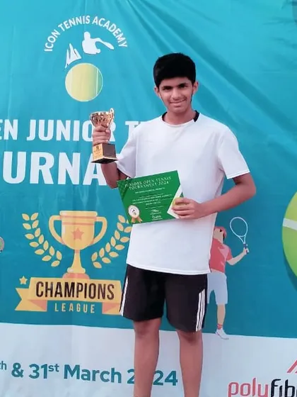 Rudra Pandey, a recent joiner, holding his first-ever title trophy from an Open Junior U12 tournament. This shows how our foundational training at the Dwarka center helps build champions quickly.