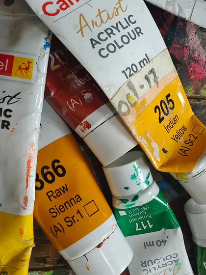 The tools of our trade. Tubes of artist-grade acrylic paint, well-used and loved, waiting to bring the next idea to life.