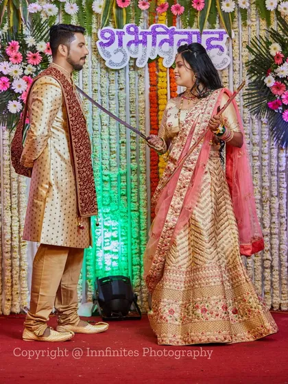 A playful moment from a traditional ceremony where the bride holds a ceremonial sword towards the groom. Capturing these unique cultural rituals is part of my service.