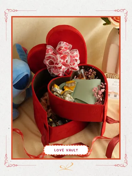 The 'Love Vault' hamper, featuring a tiered, heart-shaped red velvet box. Each layer reveals a new surprise, making the unboxing experience as special as the gifts inside. This is perfect for a dramatic and heartfelt reveal.