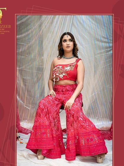 Another look at our red sharara set, showing the full flare of the pants.