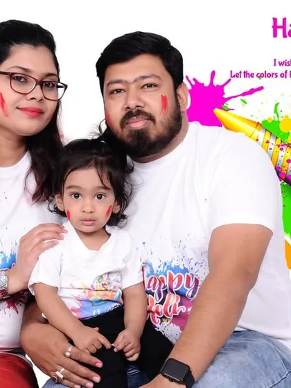 A family Holi photo with a "Happy Holi" graphic overlay. This is a great option for creating personalized festival greetings to share with friends and family.