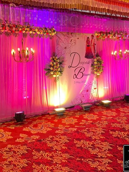 The same stage transformed for the evening with purple and pink uplighting, showing how versatile the decor can be from day to night.