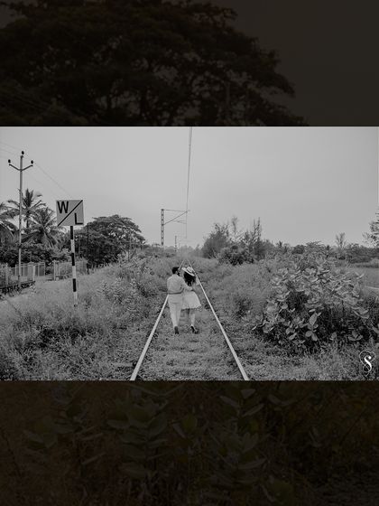 A timeless, black and white photo of the couple walking away on the tracks. This image evokes a sense of a shared future and a journey taken together.