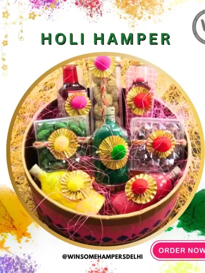 A beautifully arranged Holi hamper in a round basket, surrounded by colorful gulal. This gift set includes bottles of syrup, jars of sweets and nuts, and other festive treats, all elegantly tied with twine.