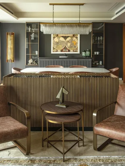 We design and craft bespoke furniture to create a cohesive architectural language. This dining area in our Barkat project features custom pieces that separate spaces while maintaining visual connection, demonstrating our focus on user-centric solutions and local craftsmanship.