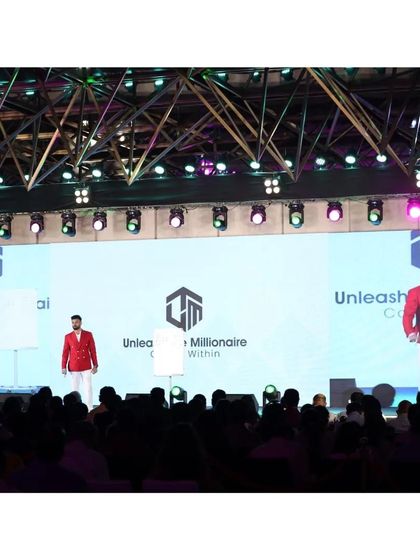 The stage view shows how a well-tailored, brightly colored blazer can have a massive visual impact, even from a distance.