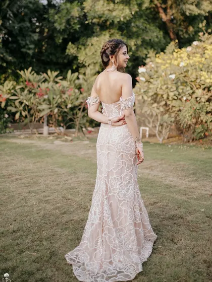 A back view showing the intricate details of the hairstyle for this Carnival look. The fishtail braid and off-the-shoulder gown create a bohemian and romantic vibe.